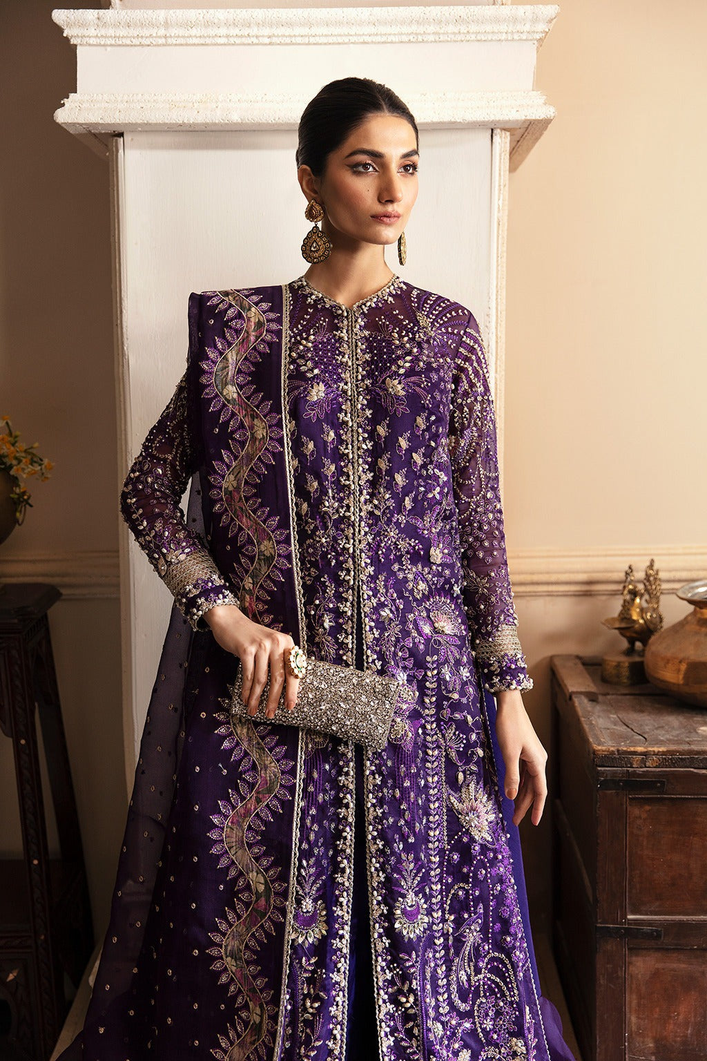 Introducing ‘MAYSA‘ the epitome of elegance and exuberance, Our Amethyst Color Organza ensemble is a harmonious blend of intricate handwork embellishment on the jacket with the side slits and daaman feature a Tribal Pattern, adding a hint of tribal allure to the dress. Complemented by graceful allure Ruffled Organza pants, This ensemble exudes opulence and distinctive style, designed to create an overall elegant look.